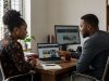 A Lagos business owner and web design consultant reviewing website mockups together during a project consultation.